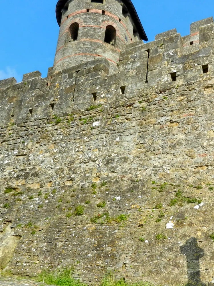 The double walls and conical-roofed towers of the Cité de Carcassonne at sunset, in Aude, southern France — a medieval fortified city restored by Viollet-le-Duc and UNESCO-listed since 1997